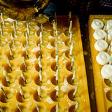 Pouring scented beeswax tea light candles